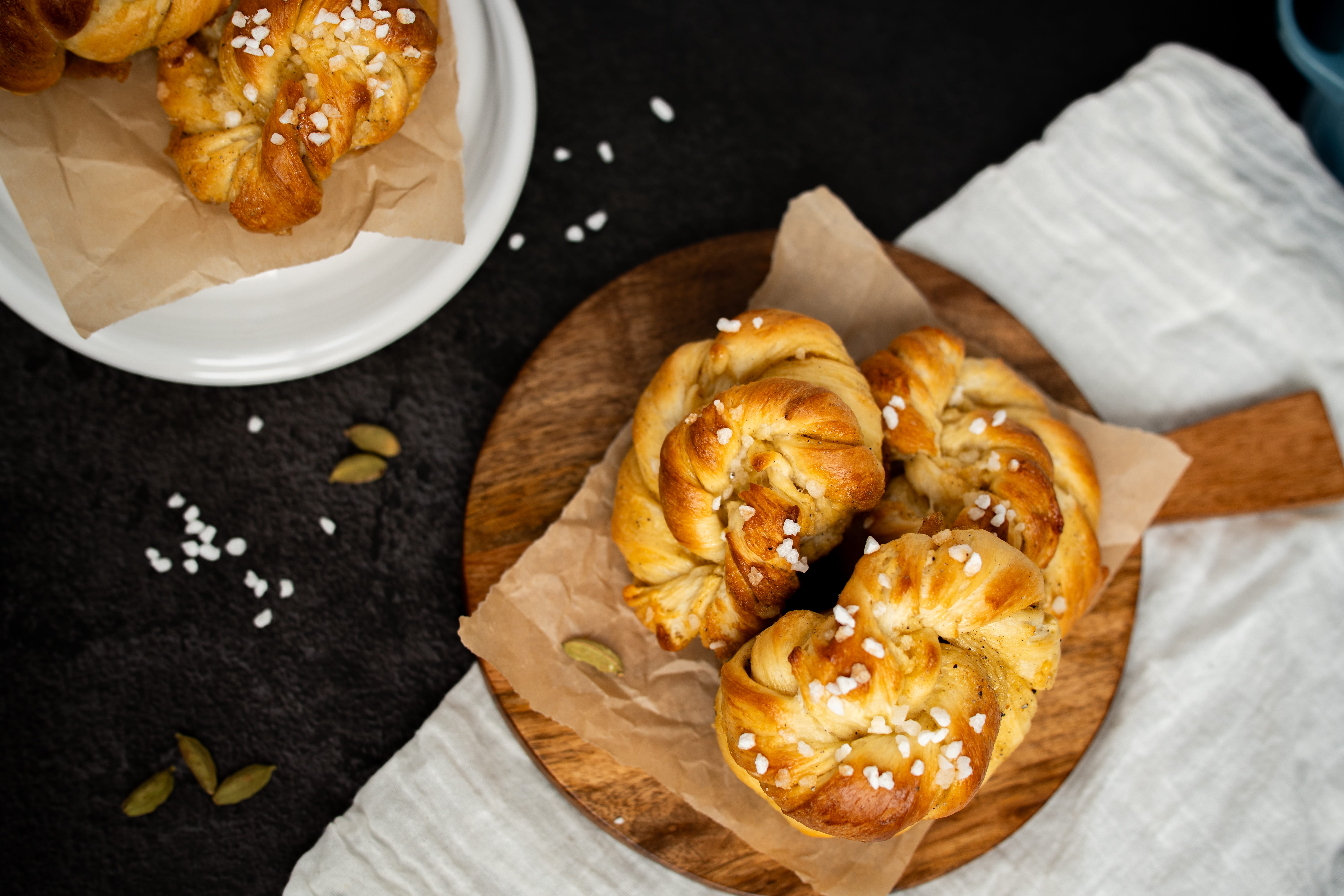 bird's eye view of cardamom buns on a wooden tray